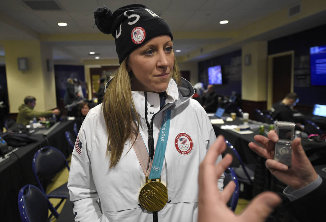 Meghan Duggan, of the gold medal winning U.S. women's Olympic hockey team, listens to a questio ...