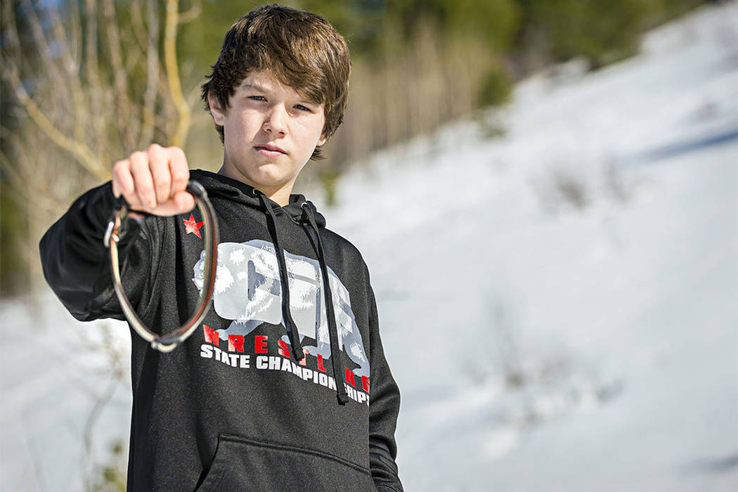 Canyon Mansfield, 14, holds the collar of his dog, Casey, on March 17, 2017. The dog was killed ...