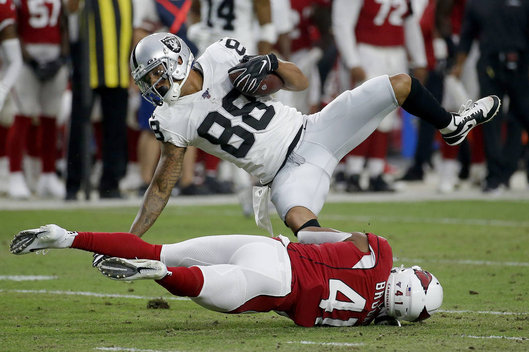 Oakland Raiders wide receiver Marcell Ateman (88) is hit by Arizona Cardinals defensive back Na ...