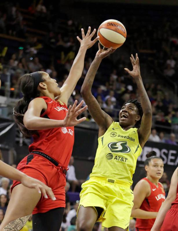 Seattle Storm's Natasha Howard, right, shoots as Las Vegas Aces' A'ja Wilson defends during the ...