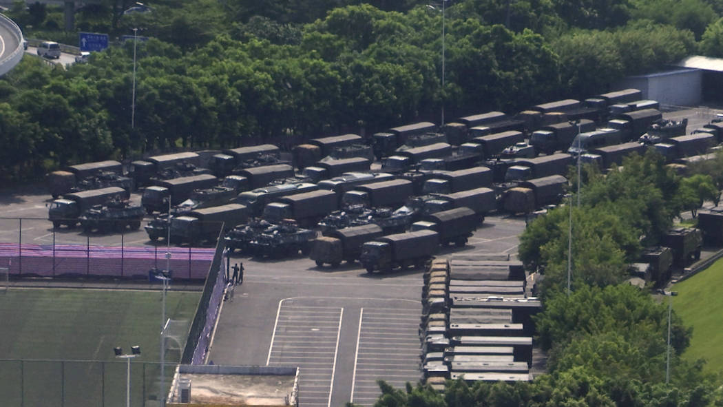 In this image made from video, armed police vehicles are parked outside Shenzhen Bay Stadium in ...