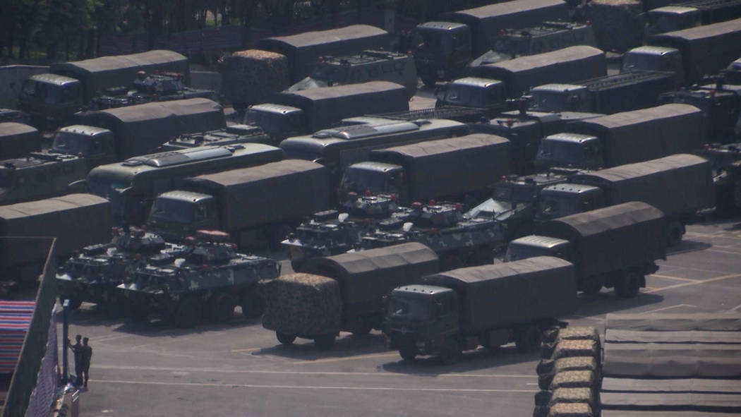 In this image made from video, armed police vehicles are parked outside Shenzhen Bay Stadium in ...