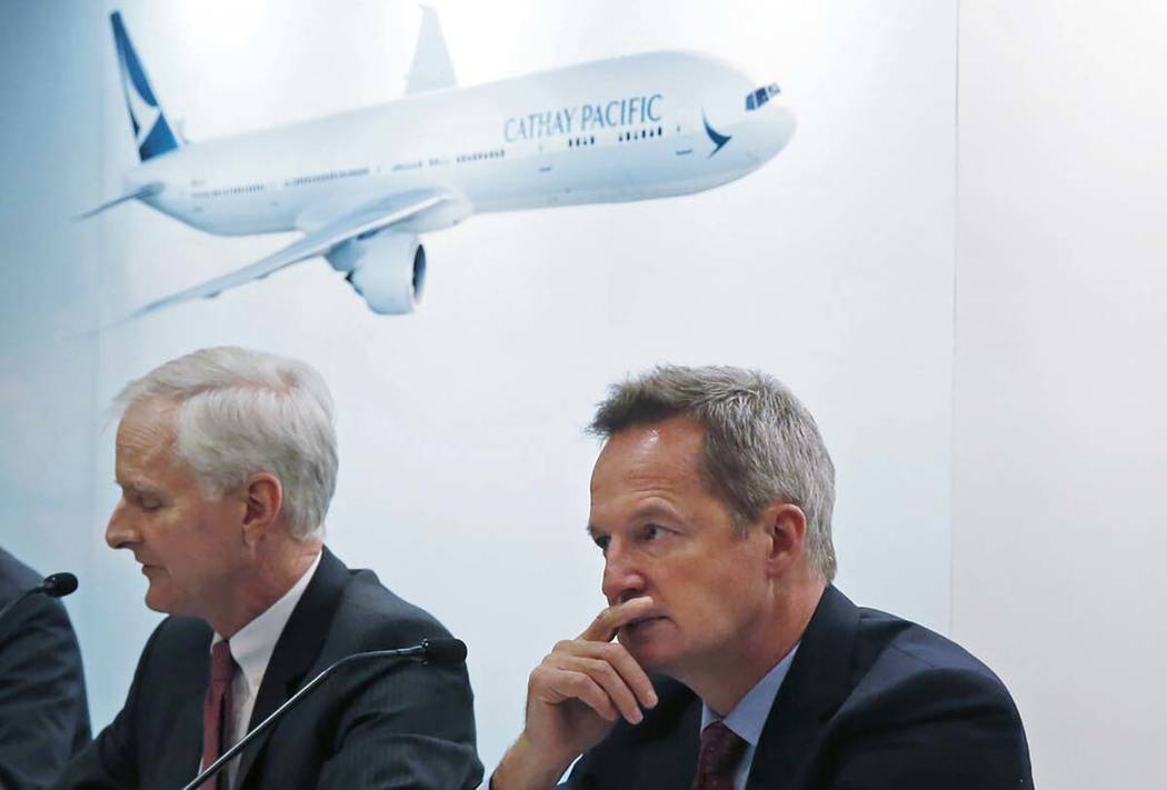 In this March 15, 2017, photo, Cathay Pacific Chief Operating Officer Rupert Hogg, right, and C ...