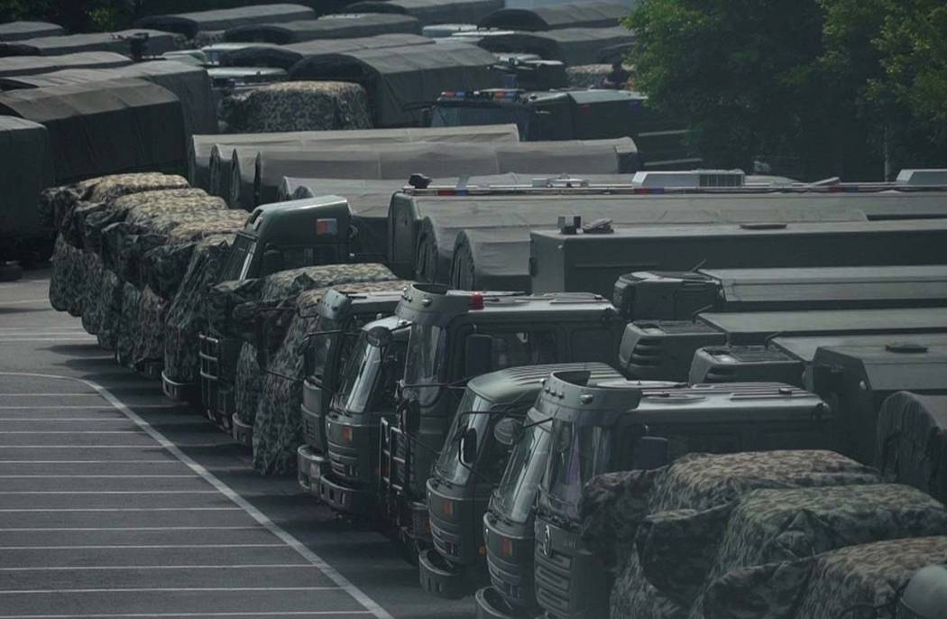 In this image made from video, armed police vehicles are parked outside Shenzhen Bay Stadium in ...