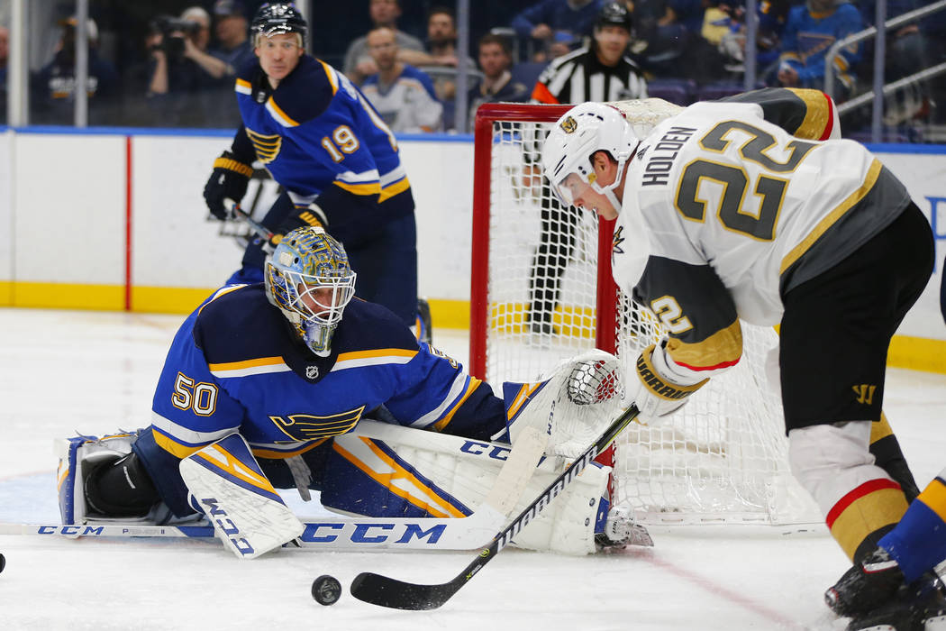 St. Louis Blues' goalie Jordan Binnington (50) and Ryan O'Reilly (90) defend the goal against V ...