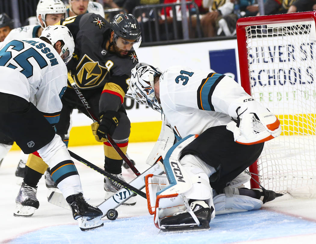 San Jose Sharks goaltender Martin Jones (31) and defenseman Erik Karlsson (65) block a shot fro ...