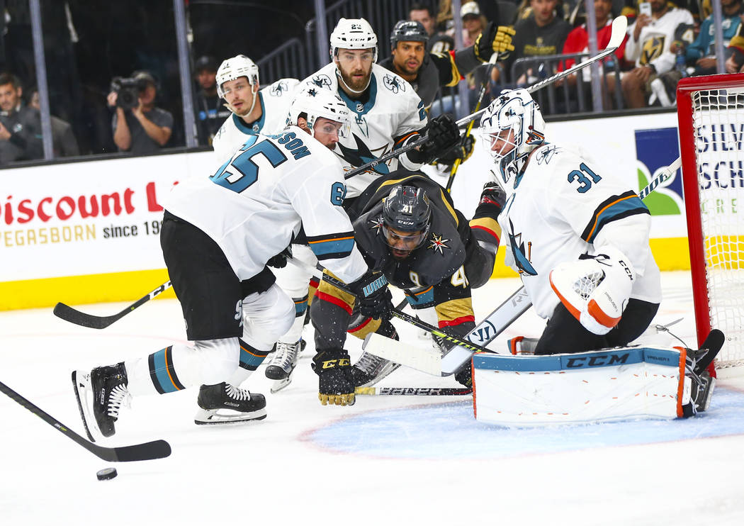 San Jose Sharks goaltender Martin Jones (31) and defenseman Erik Karlsson (65) block a shot fro ...