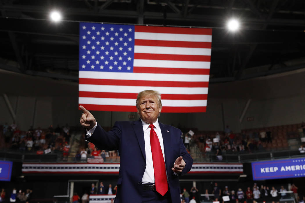 President Donald Trump reacts at the end of his speech at a campaign rally, Thursday, Aug. 15, ...