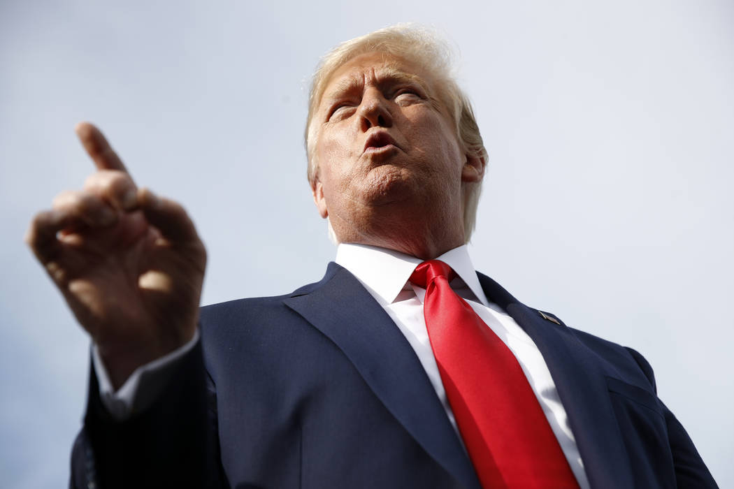 President Donald Trump speaks with reporters before boarding Air Force One at Morristown Munici ...