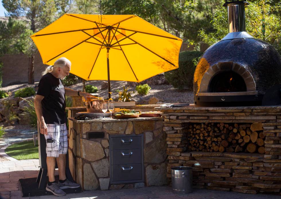 Hubert Keller, chef of Fleur de Lys and Fleur, pours rosŽ n his backyard kitchen in Las V ...