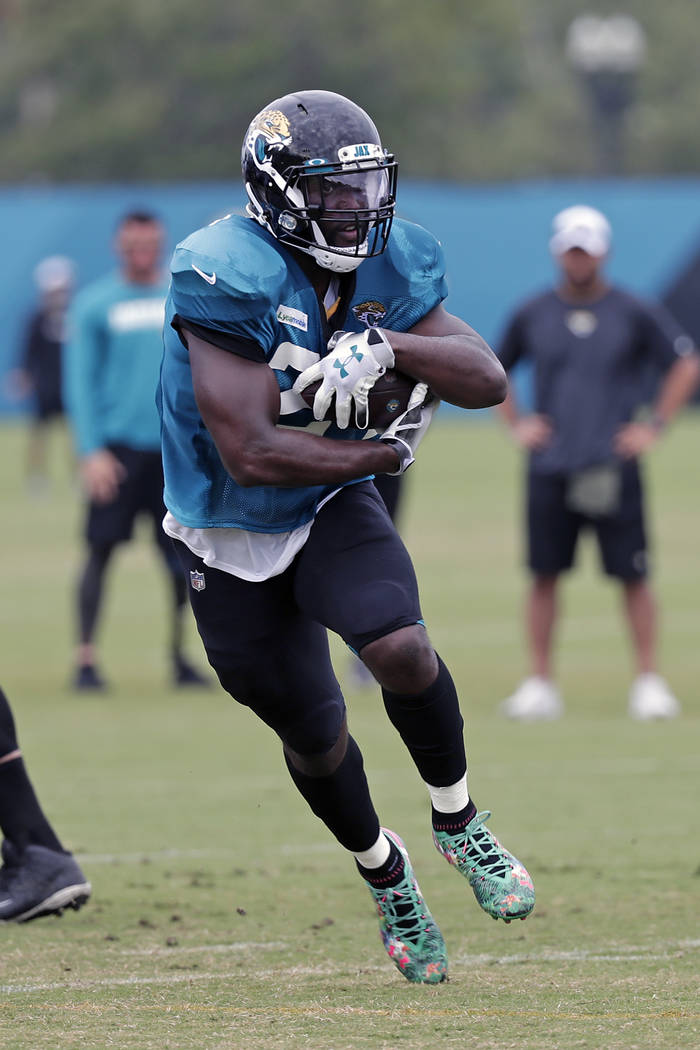 Jacksonville Jaguars running back Leonard Fournette gains yardage during an NFL football practi ...