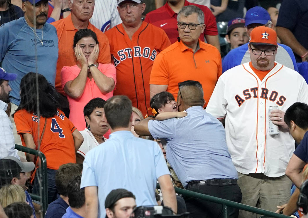 A young child is carried from the stands after being injured by a foul ball off the bat of Chic ...