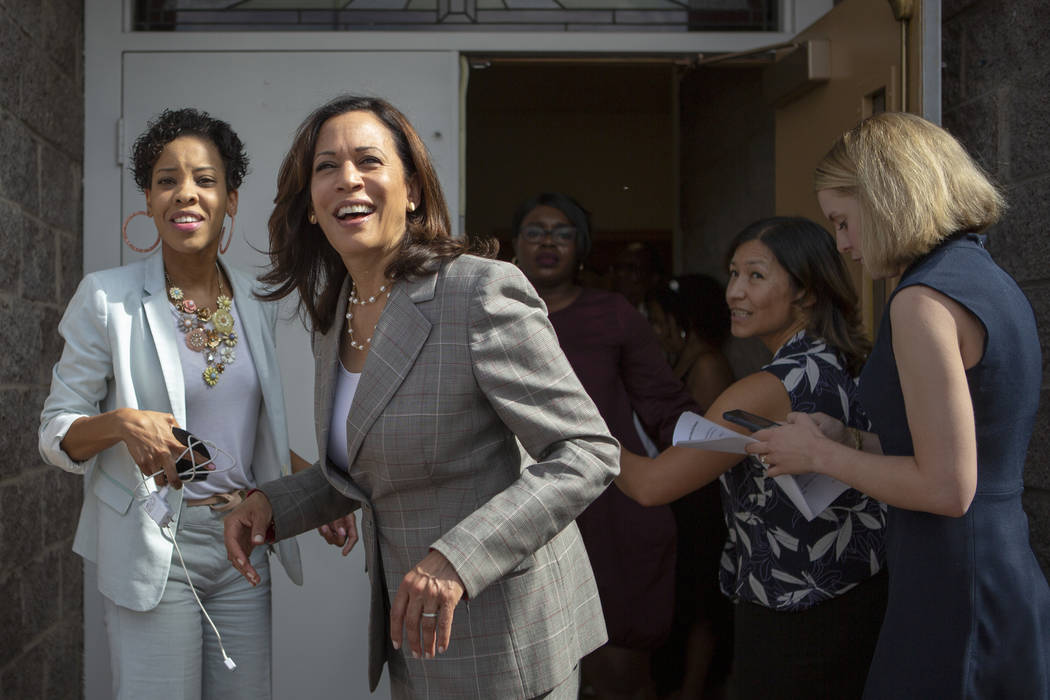 Democratic presidential candidate Sen. Kamala Harris, D-Calif., smiles with Deputy Political Di ...