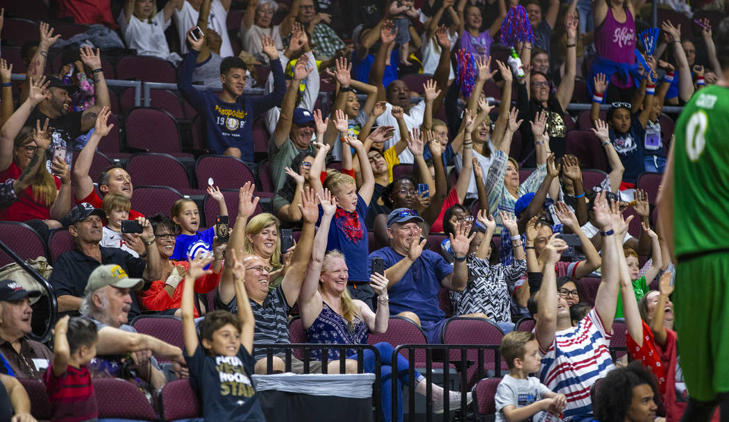 Fans do the wave in slow motion along with the Harlem Globetrotters and Washington Generals dur ...