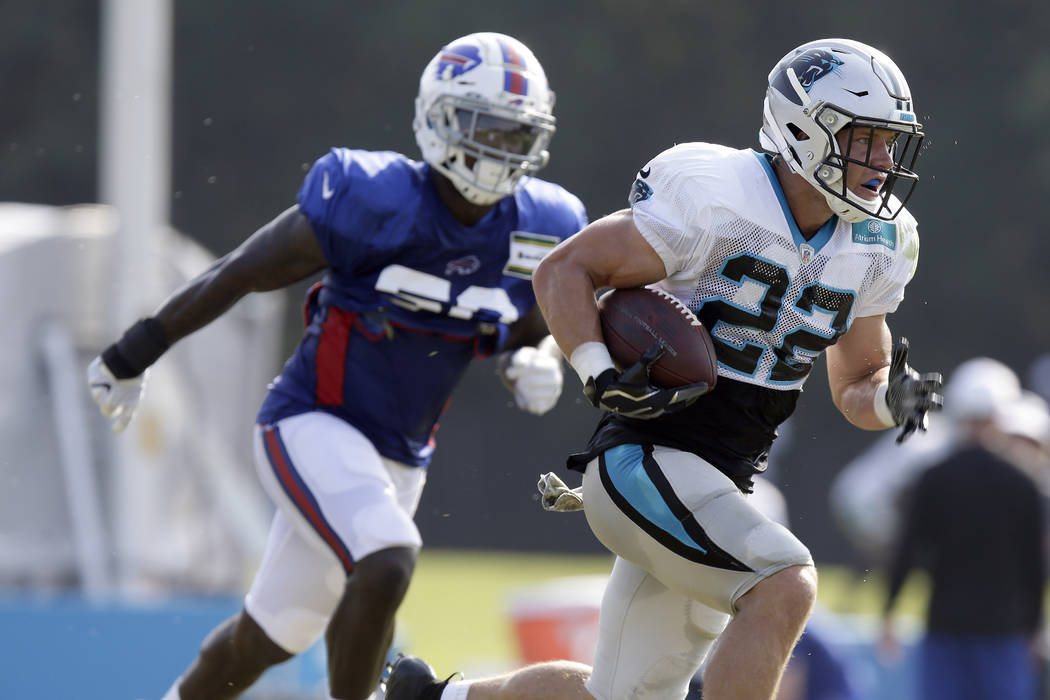 Carolina Panthers' Christian McCaffrey (22) runs while Buffalo Bills' Vosean Joseph chases duri ...