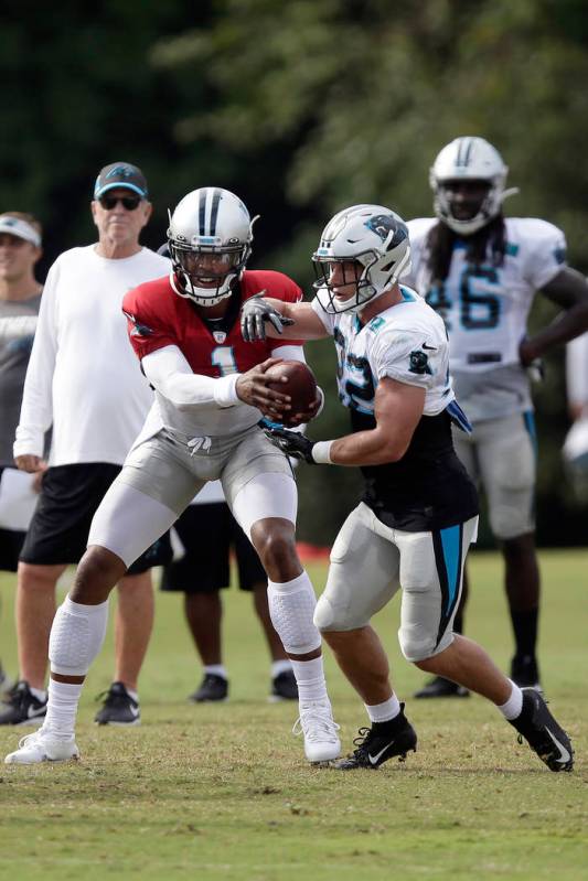 Carolina Panthers quarterback Cam Newton hands off to Christian McCaffrey during an NFL footbal ...