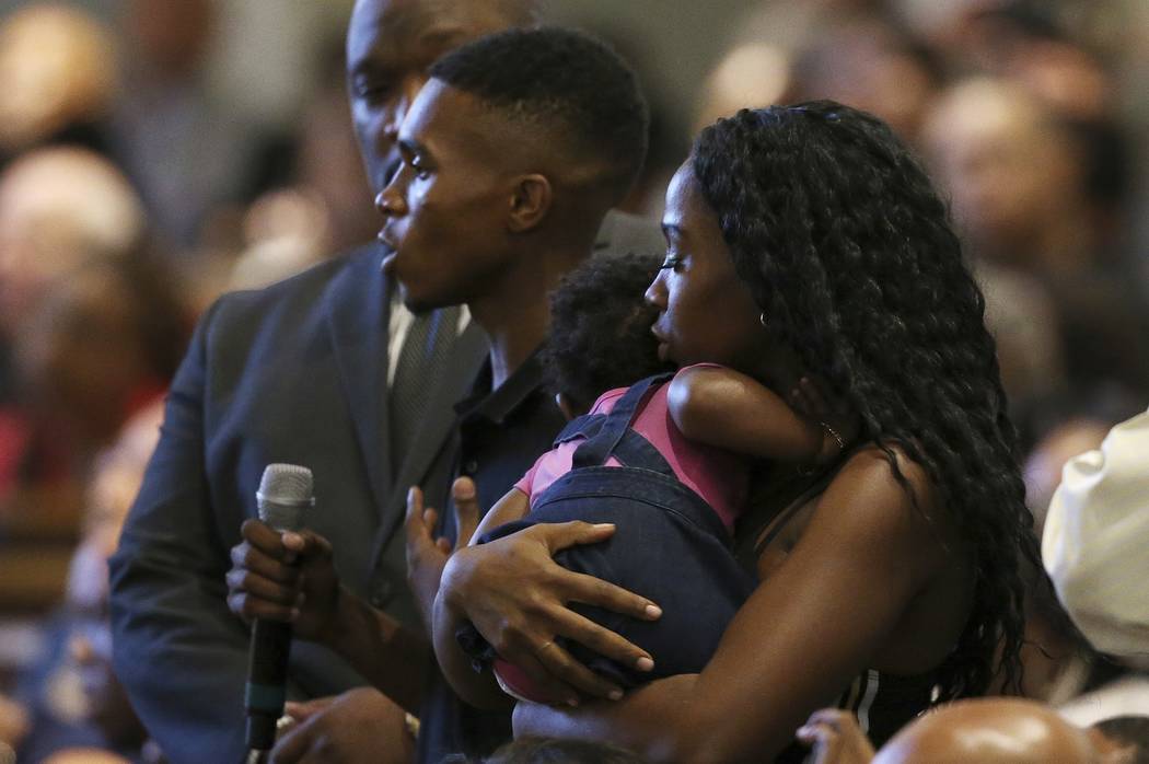 In this June 18, 2019 file photo Dravon Ames, holding microphone, speaks to Phoenix Police Chie ...