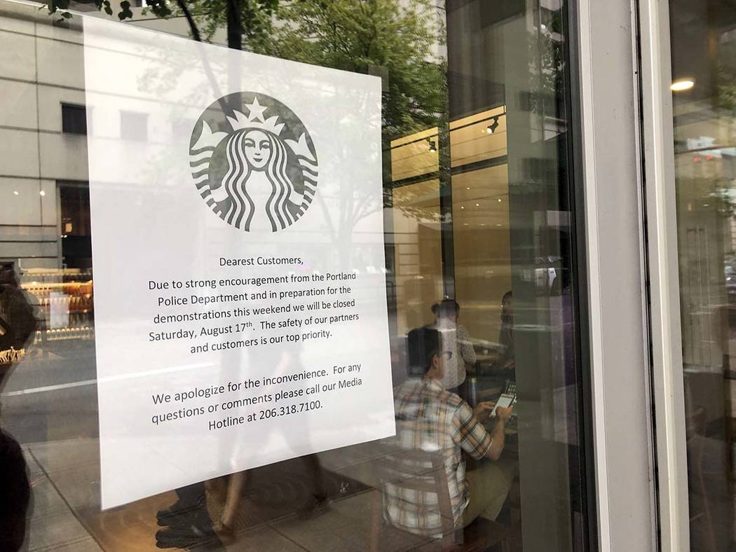 A coming closure sign is posted in the window of a Starbucks Cafe near where a large rally is p ...