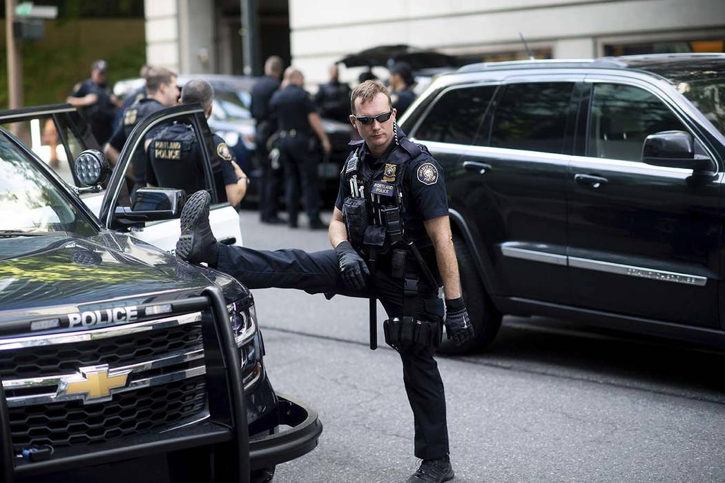 Portland police officer Bonczijk stretches before the start of a protest in Portland, Ore., on ...