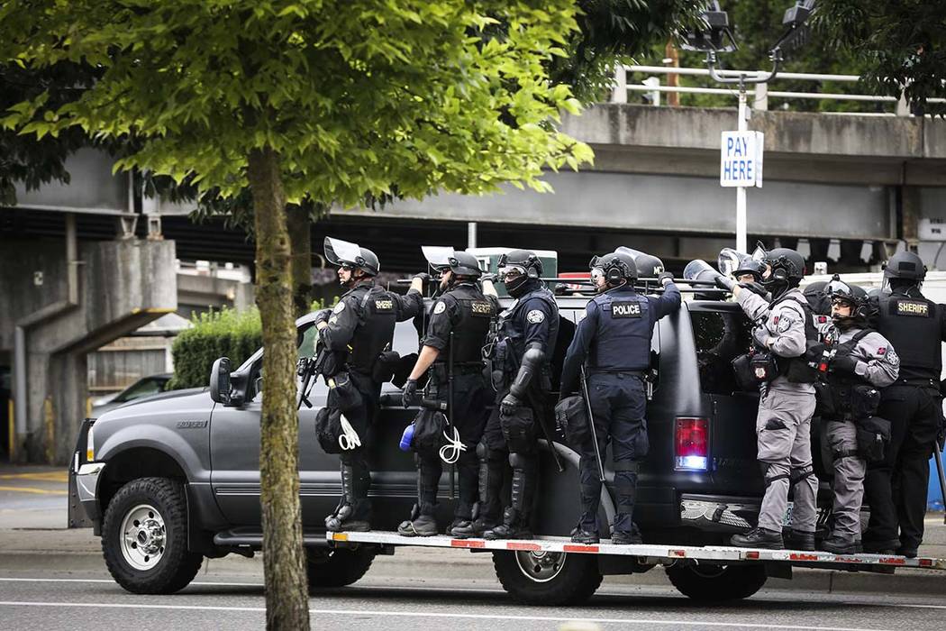 Portland Police prepare to head towards Tom McCall Waterfront Park as right-wing groups and cou ...