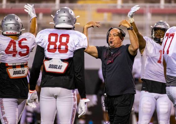 Head coach Tony Sanchez and players call for the ball and a play reset during the UNLV football ...