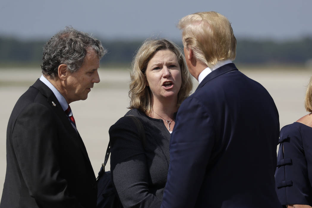 President Donald Trump is greeted by Dayton Mayor Nan Whaley and Sen. Sherrod Brown, D-Ohio, af ...