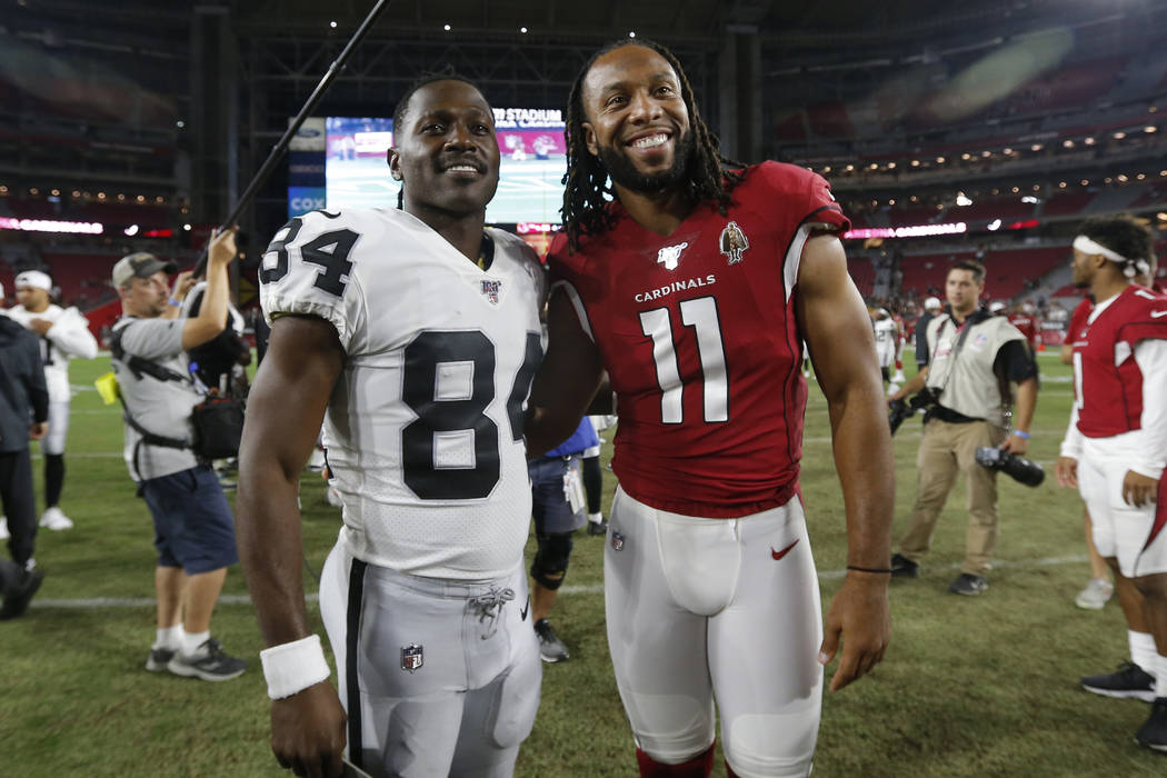 Arizona Cardinals wide receiver Larry Fitzgerald (11) and Oakland Raiders wide receiver Antonio ...