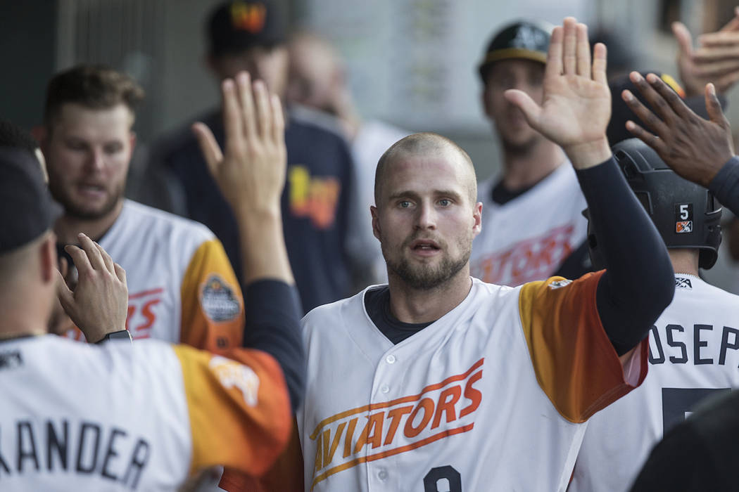 Las Vegas Aviators first baseman Seth Brown (9) high fives his teammates after scoring in the b ...