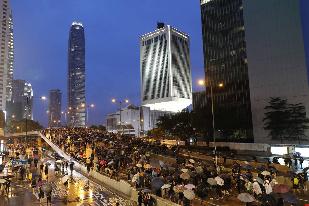 Protesters march in the rain in Hong Kong Sunday, Aug. 18, 2019. Heavy rain fell on tens of tho ...