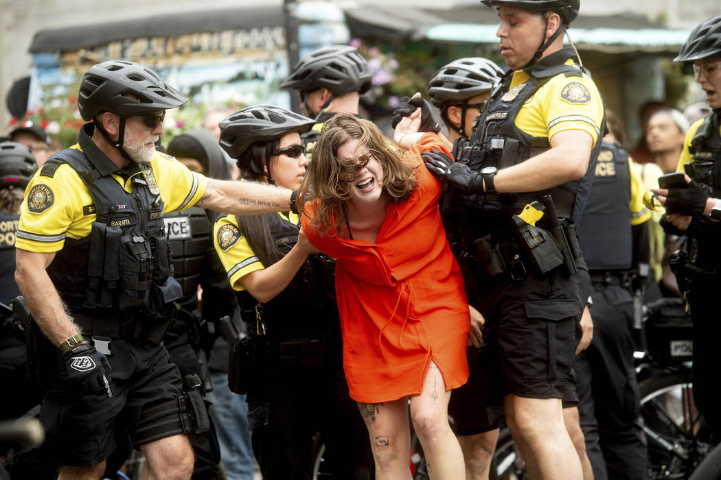 Police officers detain a protester against right-wing demonstrators following an "End Dome ...