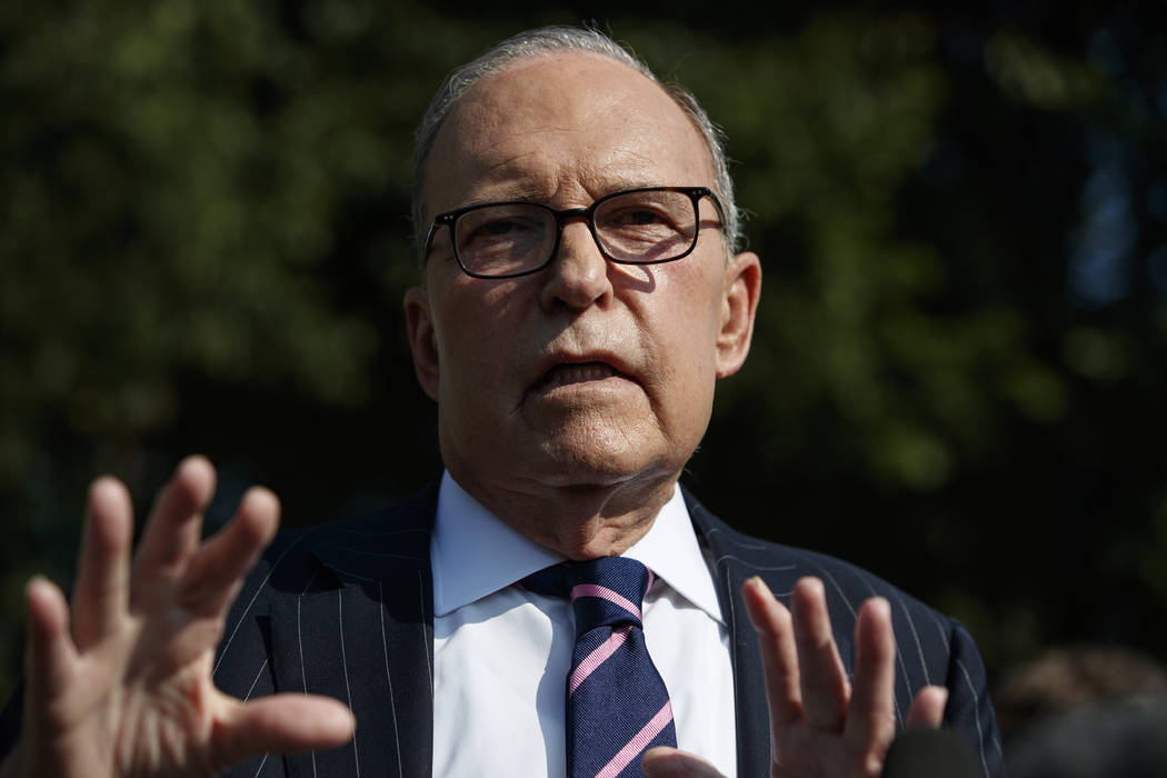 White House chief economic adviser Larry Kudlow talks with reporters outside the White House, T ...