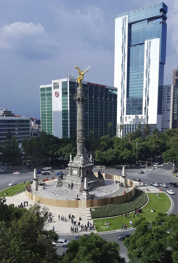 Mexican officials cordon off the iconic Angel of Independence monument after protesters defaced ...