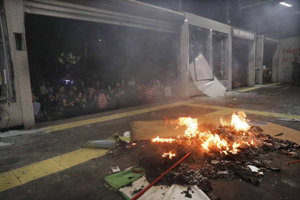 Debris burns at a bus station after protesters trashed the station during a women's march spark ...