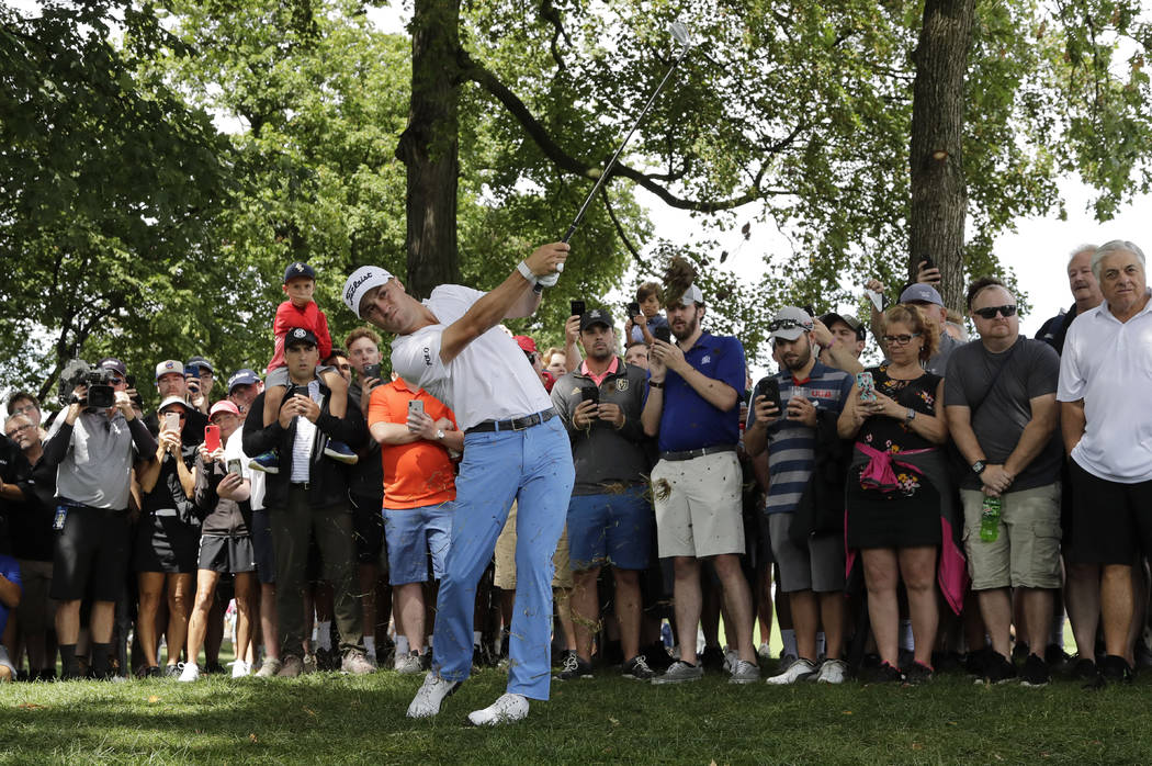 Justin Thomas hits his second shot on the first hole during the final round of the BMW Champion ...