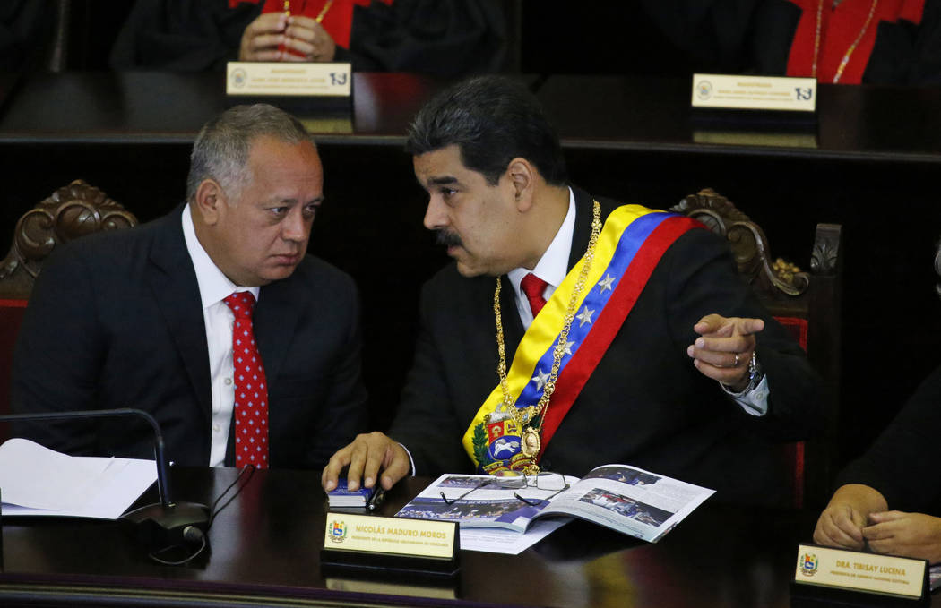 FILE - In this Jan. 24, 2019 file photo, Venezuelan President Nicolas Maduro, right, speaks wit ...