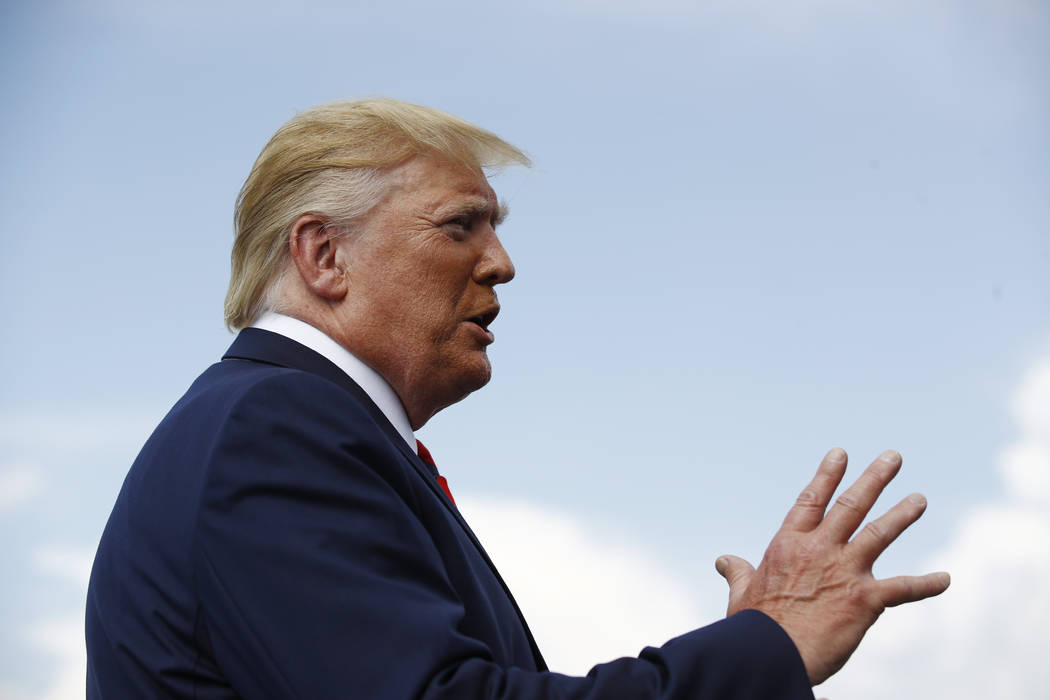 President Donald Trump speaks with reporters before boarding Air Force One at Morristown Munici ...