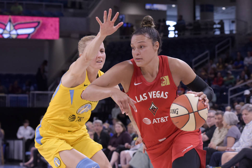 Las Vegas Aces' Kayla McBride drives around the Chicago Sky's Allie Quigley during first half o ...