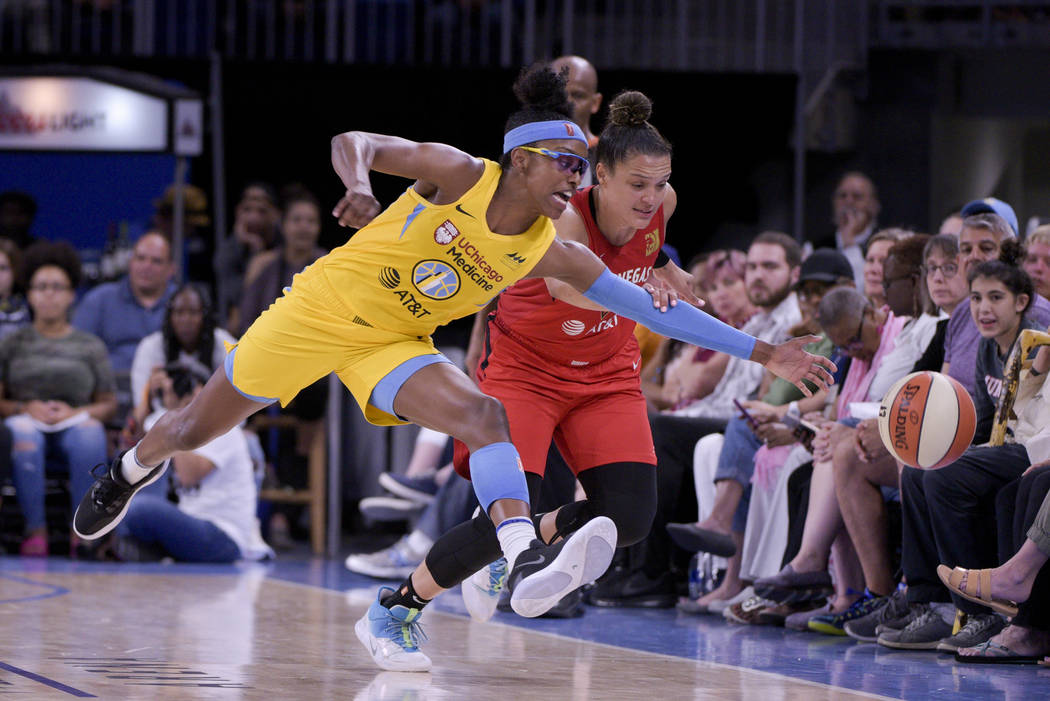 Chicago Sky's Diamond DeShields and Las Vegas Aces' Kayla McBride scramble after a loose ball d ...