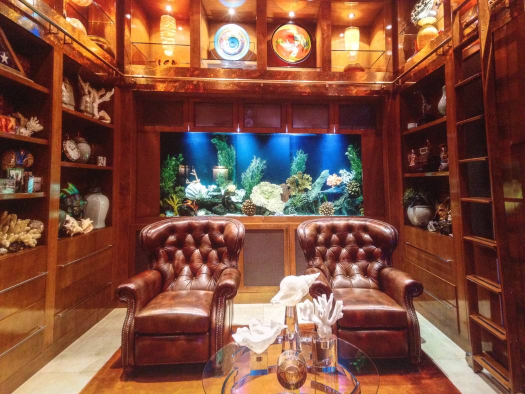 The Red Rock Country Club home has a 350-gallon freshwater fish tank built into the bookcase an ...