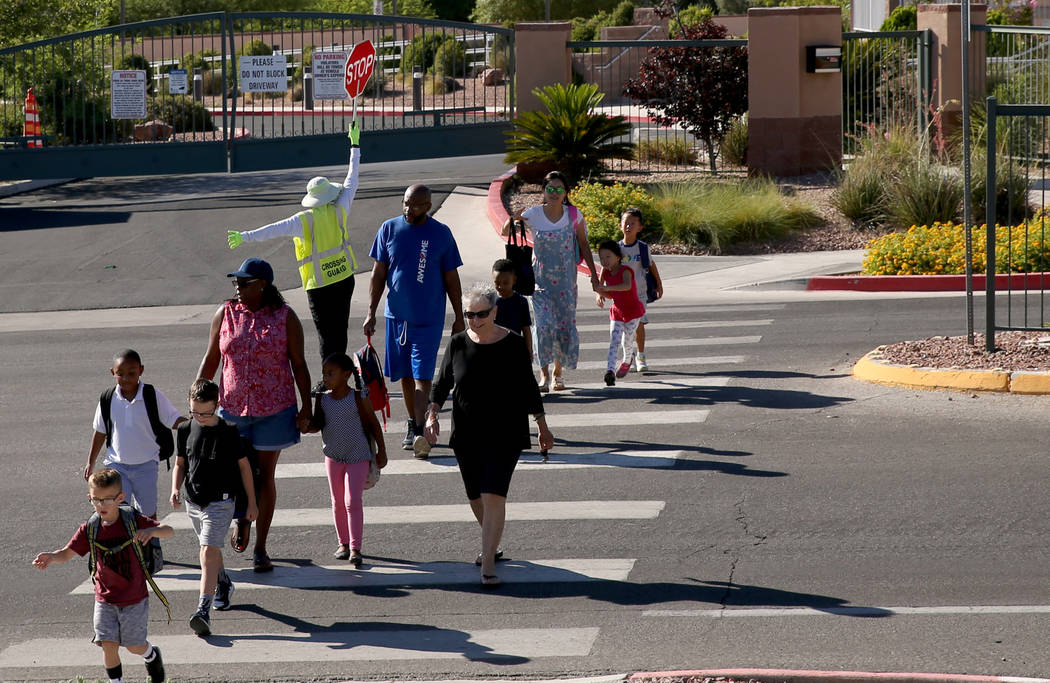 Parents take their children to school at Staton Elementary School in Las Vegas Tuesday, Aug. 20 ...