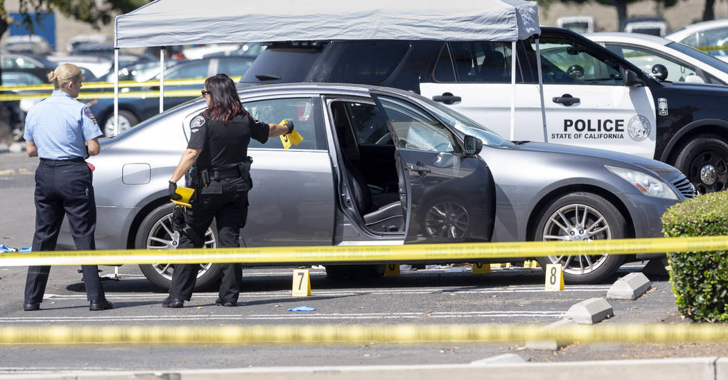 Police investigate a car where a retired Cal State Fullerton administrator was stabbed to death ...