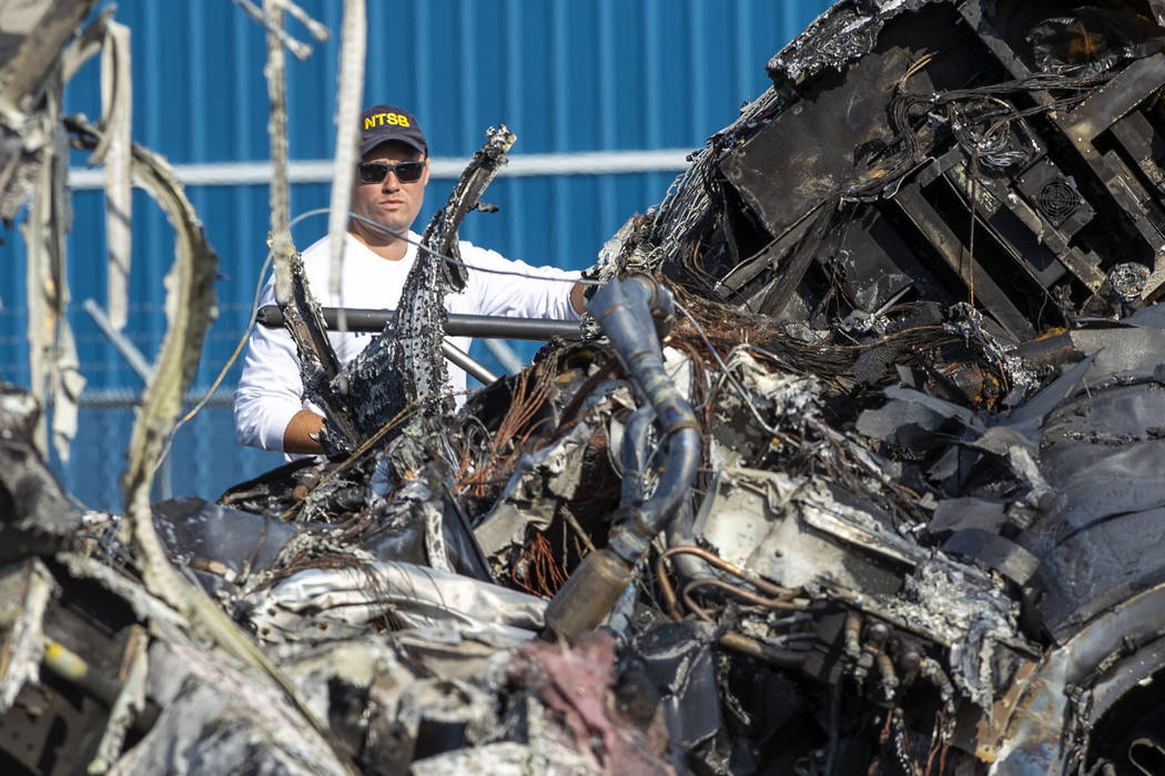 A member of the National Transportation Safety Board looks at the wreckage of a plane that Dale ...