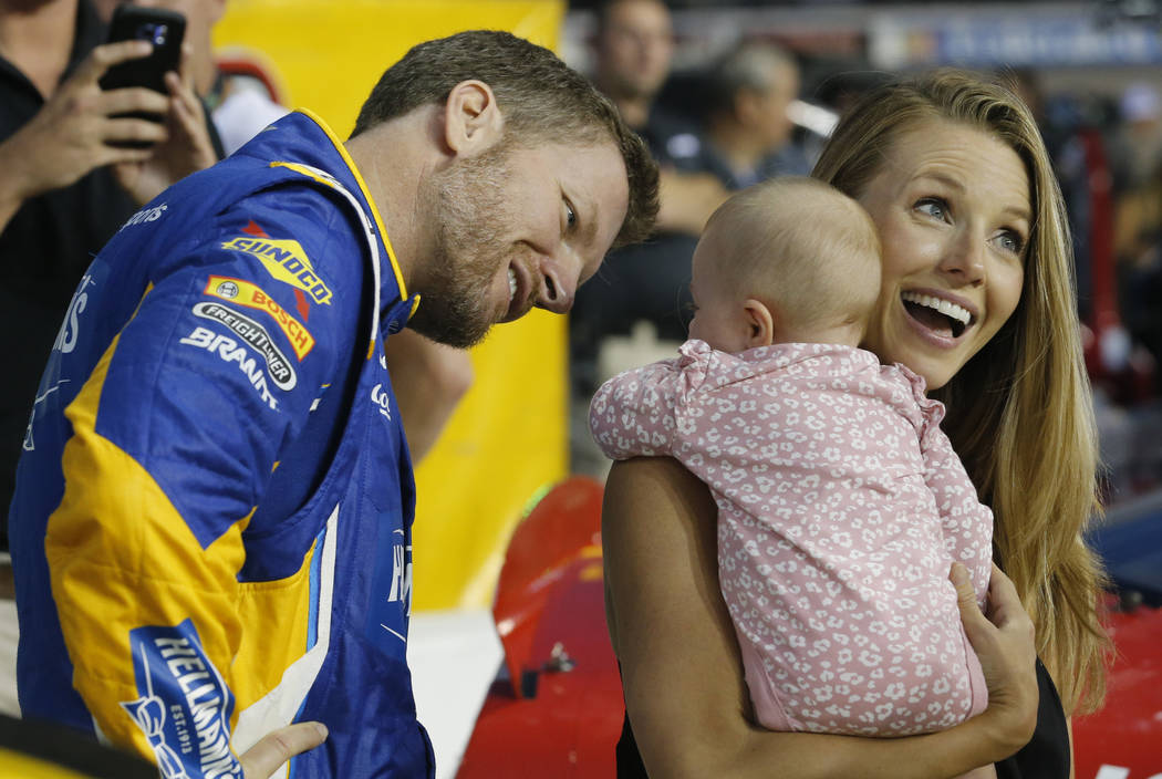 FILE - In this Sept. 21, 2018, file photo, Dale Earnhardt Jr. looks at his daughter, Isla, and ...