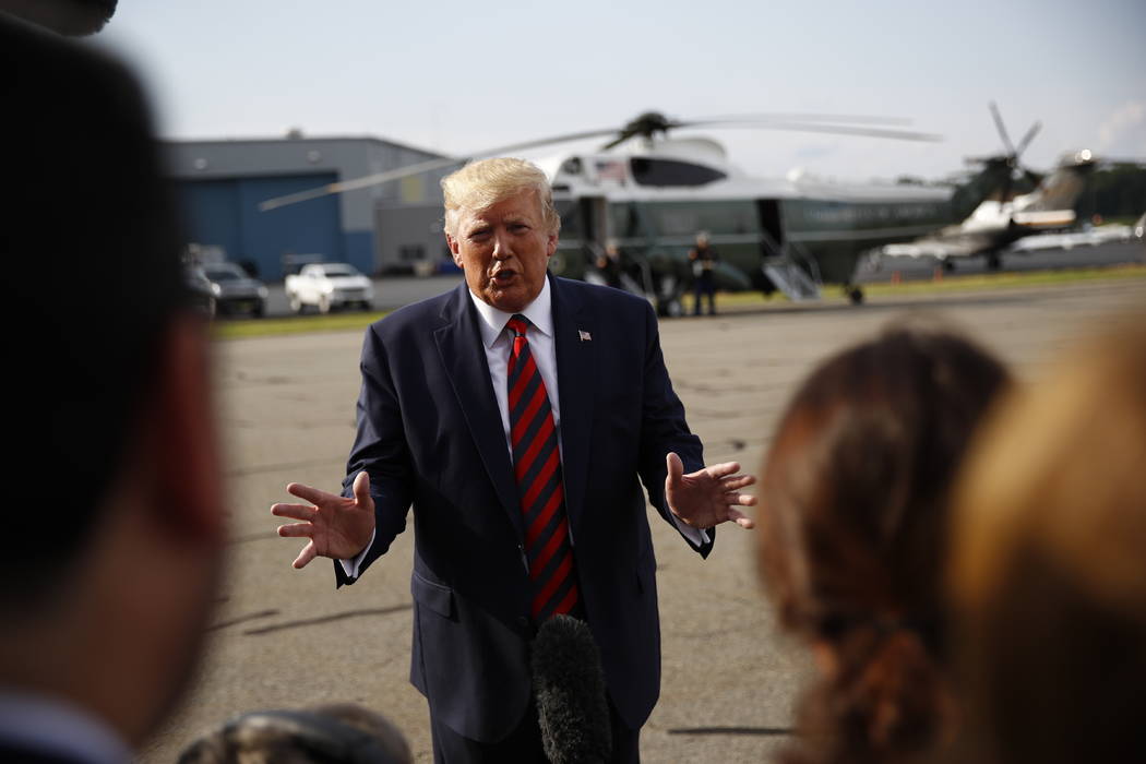 President Donald Trump speaks with reporters before boarding Air Force One at Morristown Munici ...