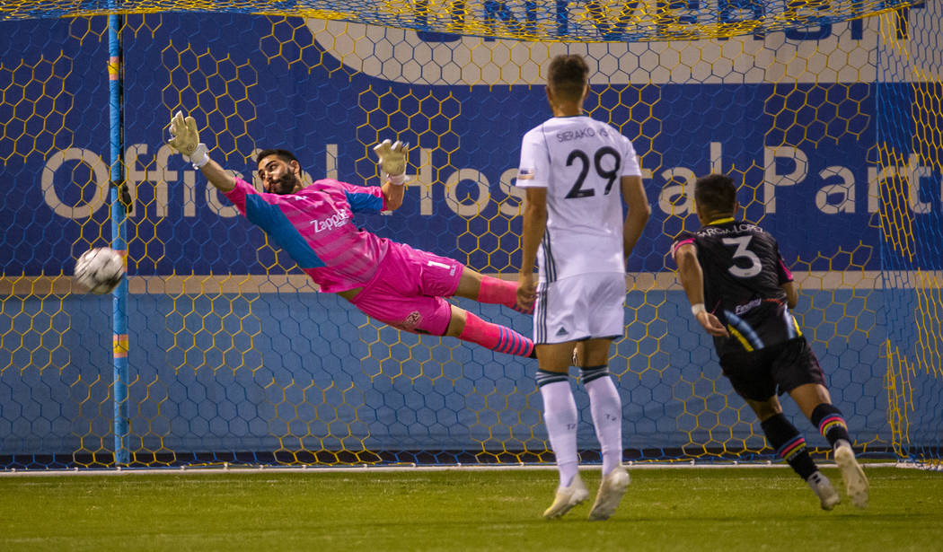 Las Vegas Lights FC goalkeeper Thomas Olsen (1) deflects another shot on goal as Portland Timbe ...