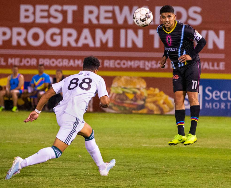 Las Vegas Lights FC forward Irvin Parra (11, right) heads the ball towards a teammate past Port ...