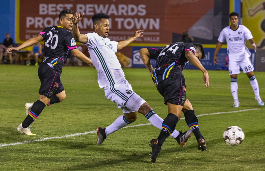 Las Vegas Lights FC forward Jose Villarreal (24, right) sends a kick into the net with Portland ...