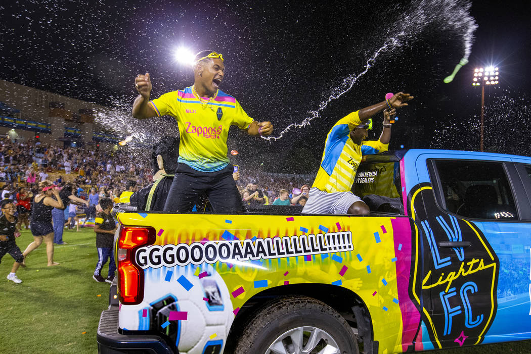 Las Vegas Lights FC staffers Lester Izquierdo, left, and Bojo Ackah battle the fans on field d ...