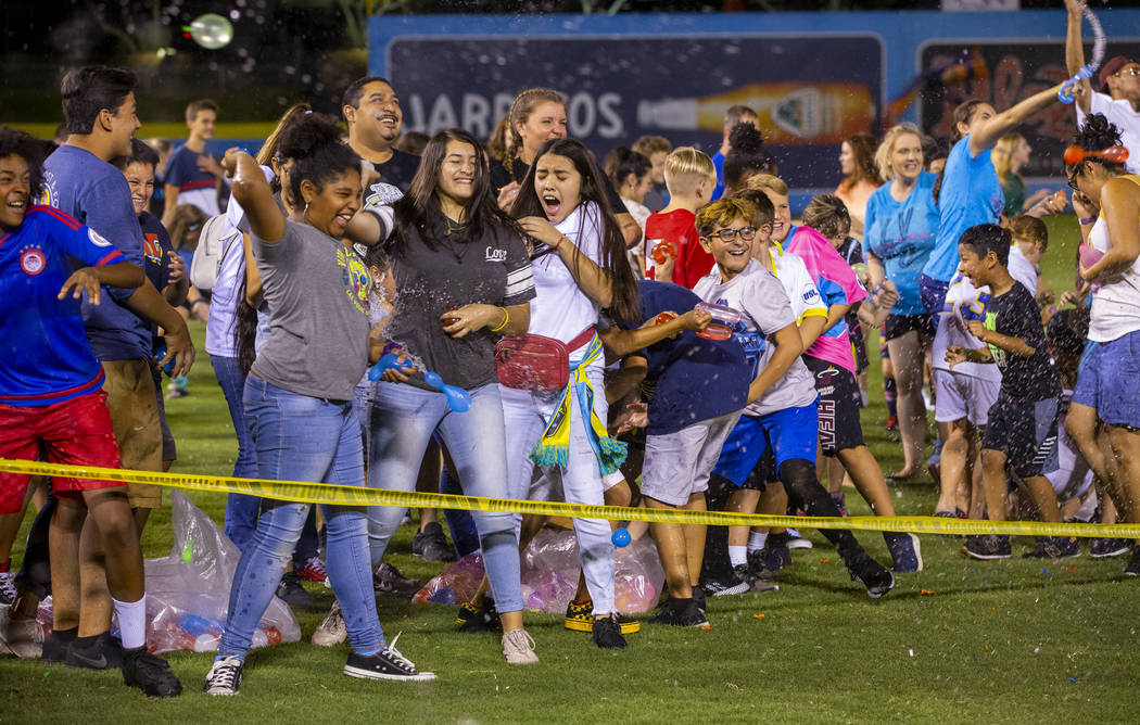 Las Vegas Lights FC fans enjoy a massive water balloon fight on field at halftime during their ...