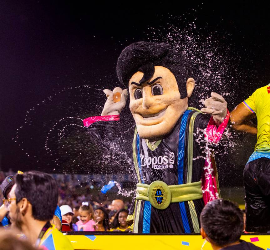 Las Vegas Lights FC mascot Cash the Soccer Rocker is pelted by fans on field during a massive w ...